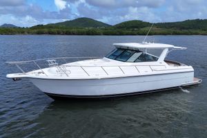 Tiara Yachts 4000 Express 2003 Tiara Yachts 4000 Express cruising on a scenic lake with lush green hills.