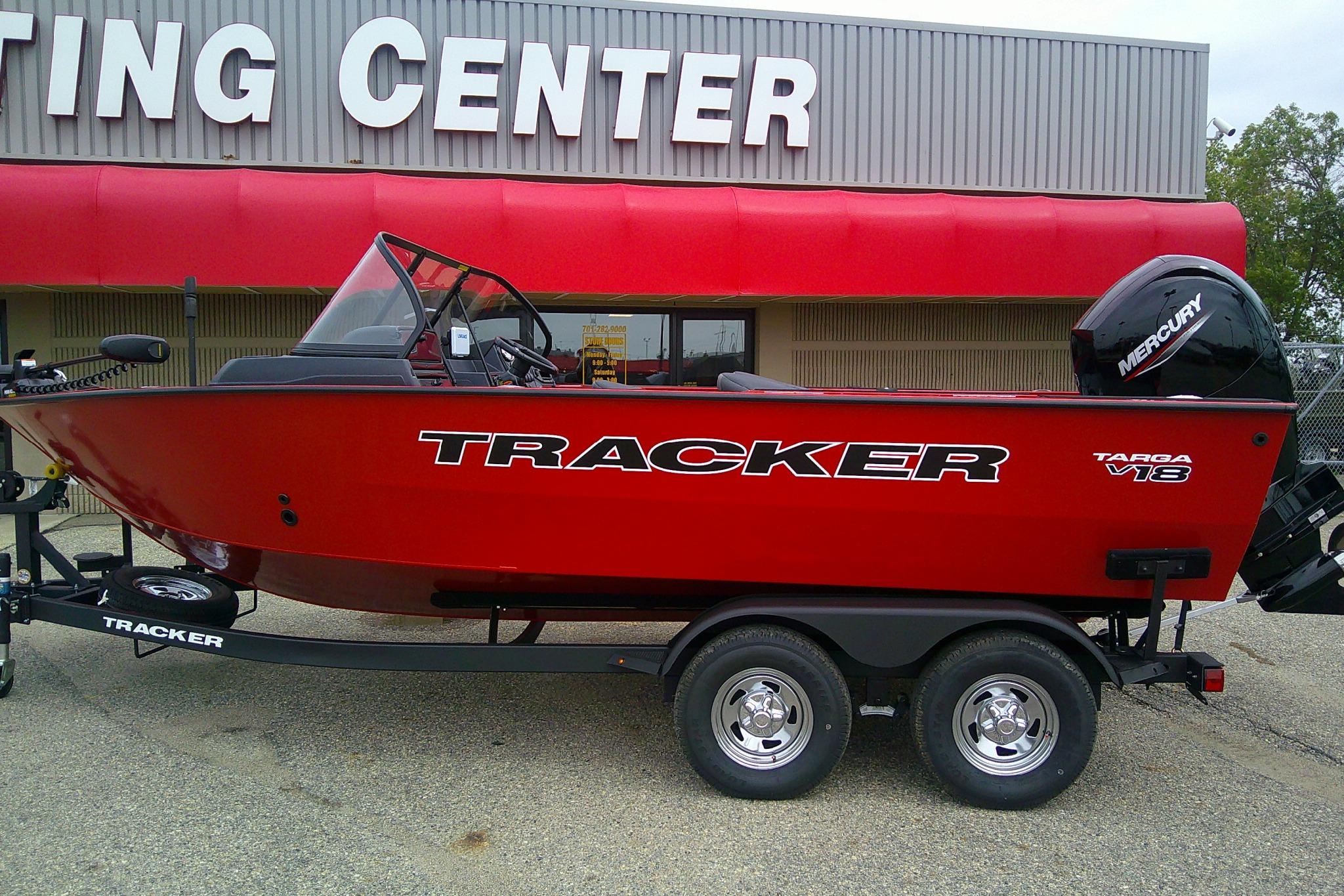 Tracker Targa V-18 Combo 2026 Tracker Targa V-18 Combo boat in red, parked outside a boating center.