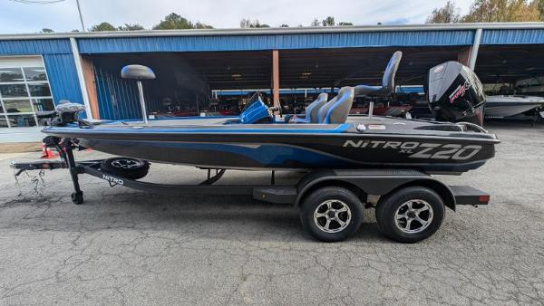 Nitro Z20 XL Pro 2025 Nitro Z20 XL Pro fishing boat on trailer, parked outside a blue building.