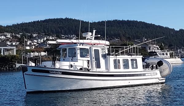 Nordic Tug 32 2006 Nordic Tug 32 boat on water with scenic background.