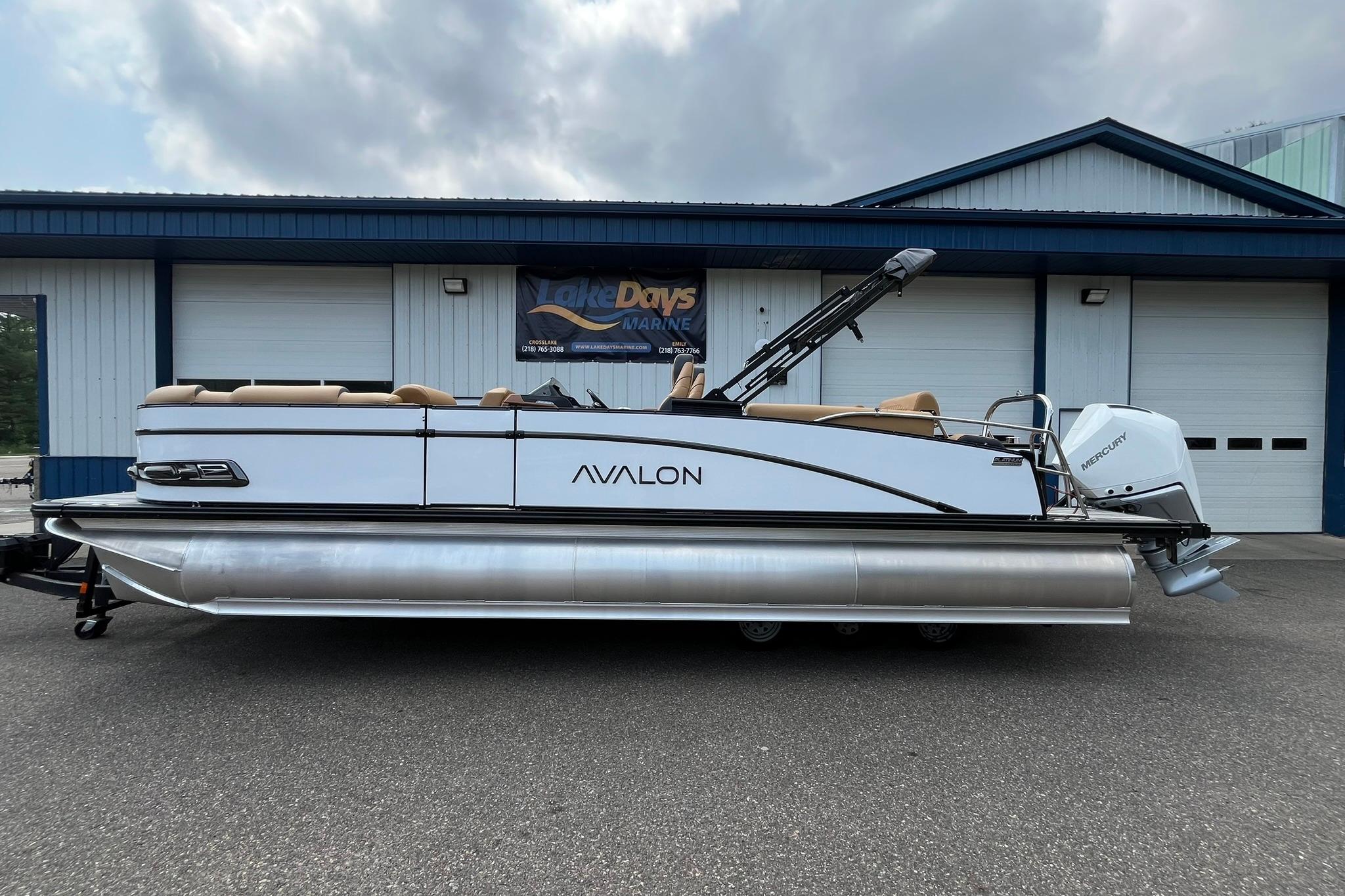 Avalon Catalina Quad Lounger Shift Windshield 2025 Avalon Catalina Quad Lounger Shift Windshield pontoon boat parked outside a building.
