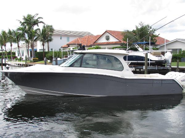 Grady-White Freedom 415 2024 Grady-White Freedom 415 boat docked near waterfront homes.