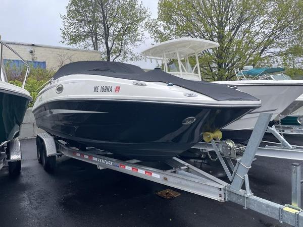 Sea Ray 260 Sundeck 2012 Sea Ray 260 Sundeck boat on trailer, covered, parked outdoors.