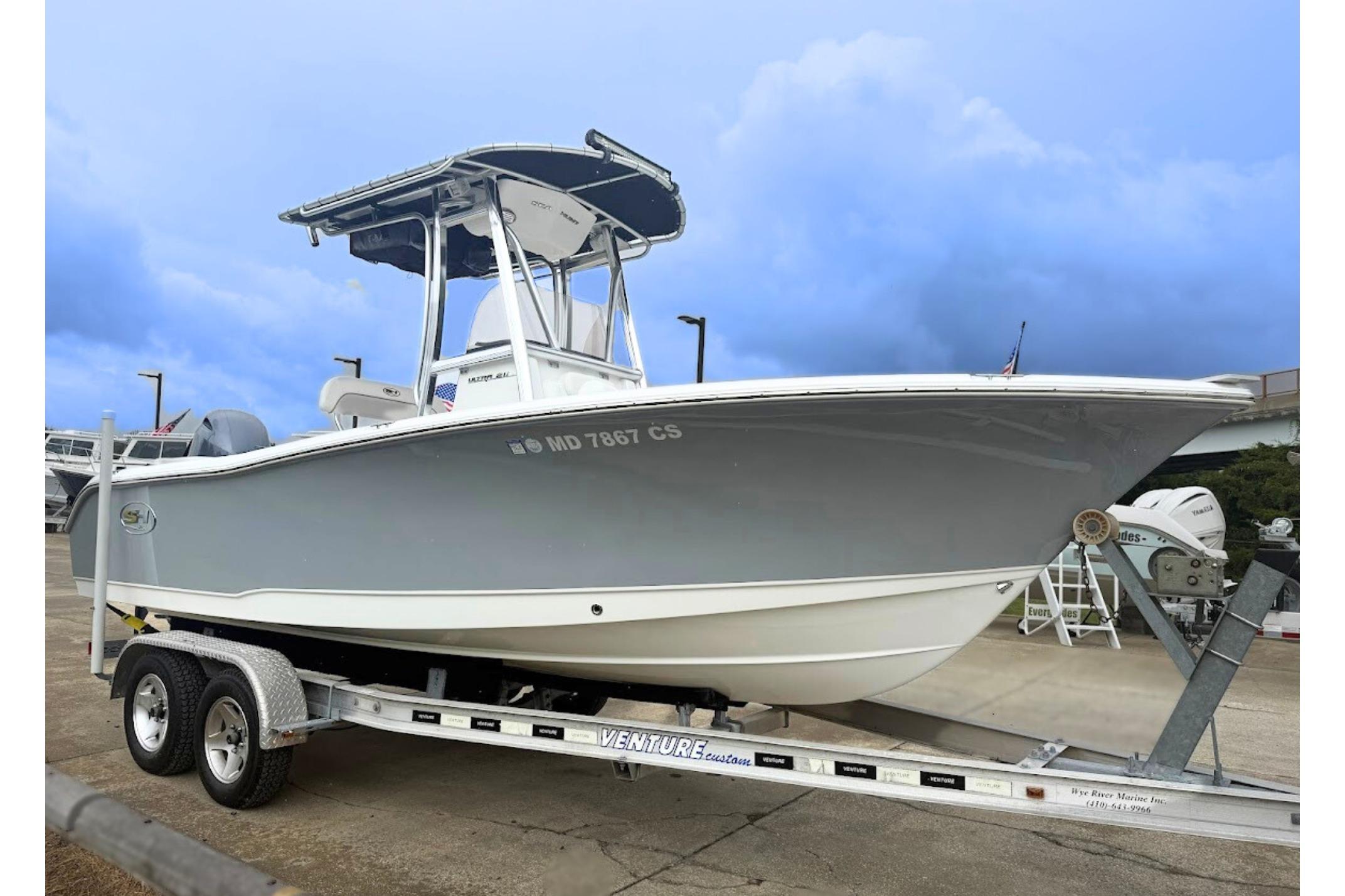 Sea Hunt Ultra 211 2018 Sea Hunt Ultra 211 boat on trailer, parked outdoors under cloudy sky.