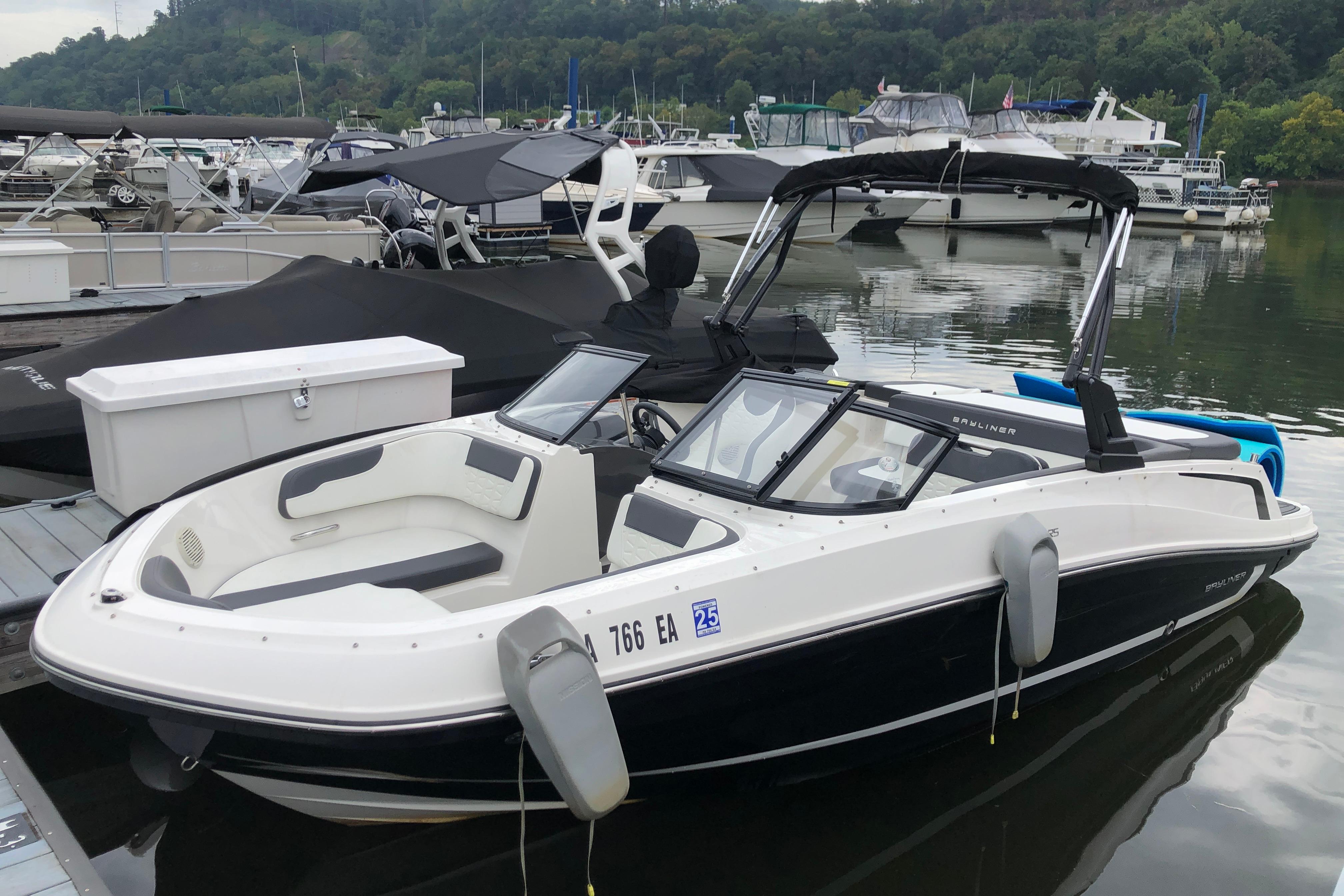 Bayliner VR5 Bowrider I/O 2021 Bayliner VR5 Bowrider I/O docked at marina, surrounded by other boats.