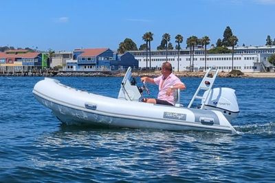 Tide Craft Nantucker 12 2025 Tide Craft Nantucker 12 boat cruising on water with scenic coastal backdrop. Boat