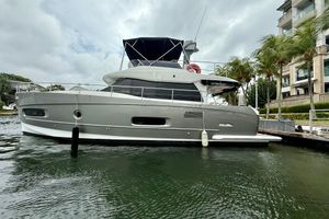 Azimut Magellano 43 2017 Azimut Magellano 43 yacht docked by palm trees and modern buildings.