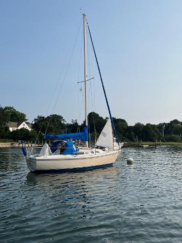 Catalina Sailboat 1985 Catalina sailboat on calm water with clear sky background.