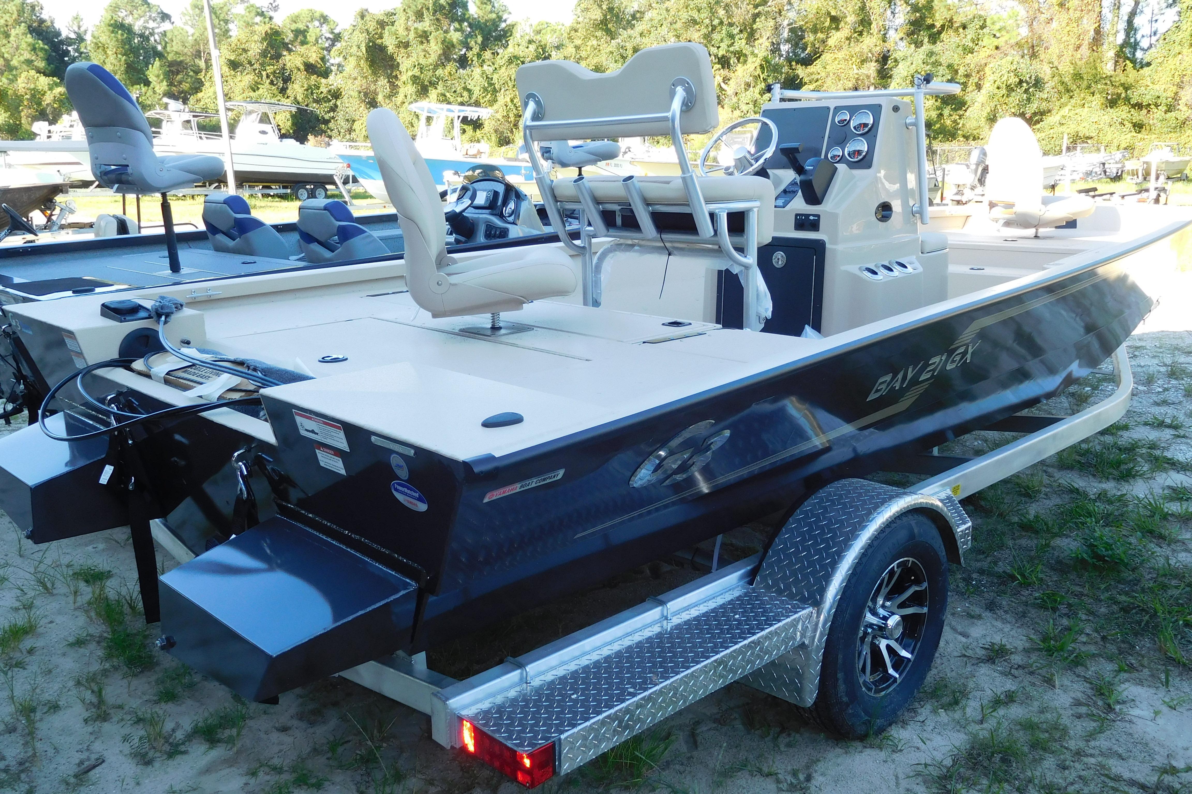G3 Bay 21 GX 2025 G3 Bay 21 GX boat on trailer, featuring sleek design and modern controls.