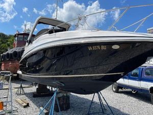 Regal 28 Express 2014 Regal 28 Express boat on stands, black hull, clear sky background.