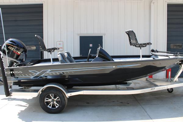 Xpress H18C Crappie 2026 Xpress H18C Crappie boat on trailer, black exterior, parked outside a building.
