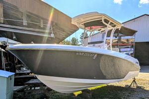 Wellcraft 242 Fisherman 2018 Wellcraft 242 Fisherman boat on display in a storage area, sunlight reflecting off hull.