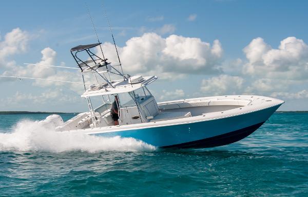 Contender 39 ST 2019 Contender 39 ST boat cruising on clear blue water under a sunny sky.