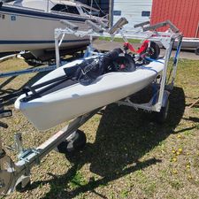 RS rs neo 2017 RS Neo sailboat on trailer, parked outdoors near other boats.