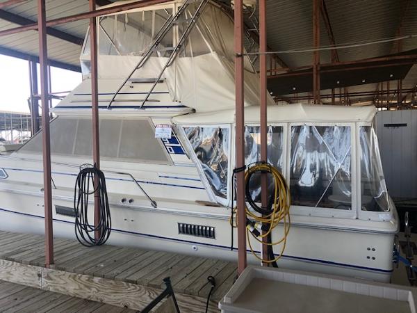 Sea Ray 390 Sport Fisherman 1983 Sea Ray 390 Sport Fisherman docked in a covered marina.