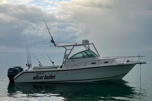 Pursuit 2870 Walkaround 2003 Pursuit 2870 Walkaround boat named "Silver Bullet" on calm water under cloudy sky.