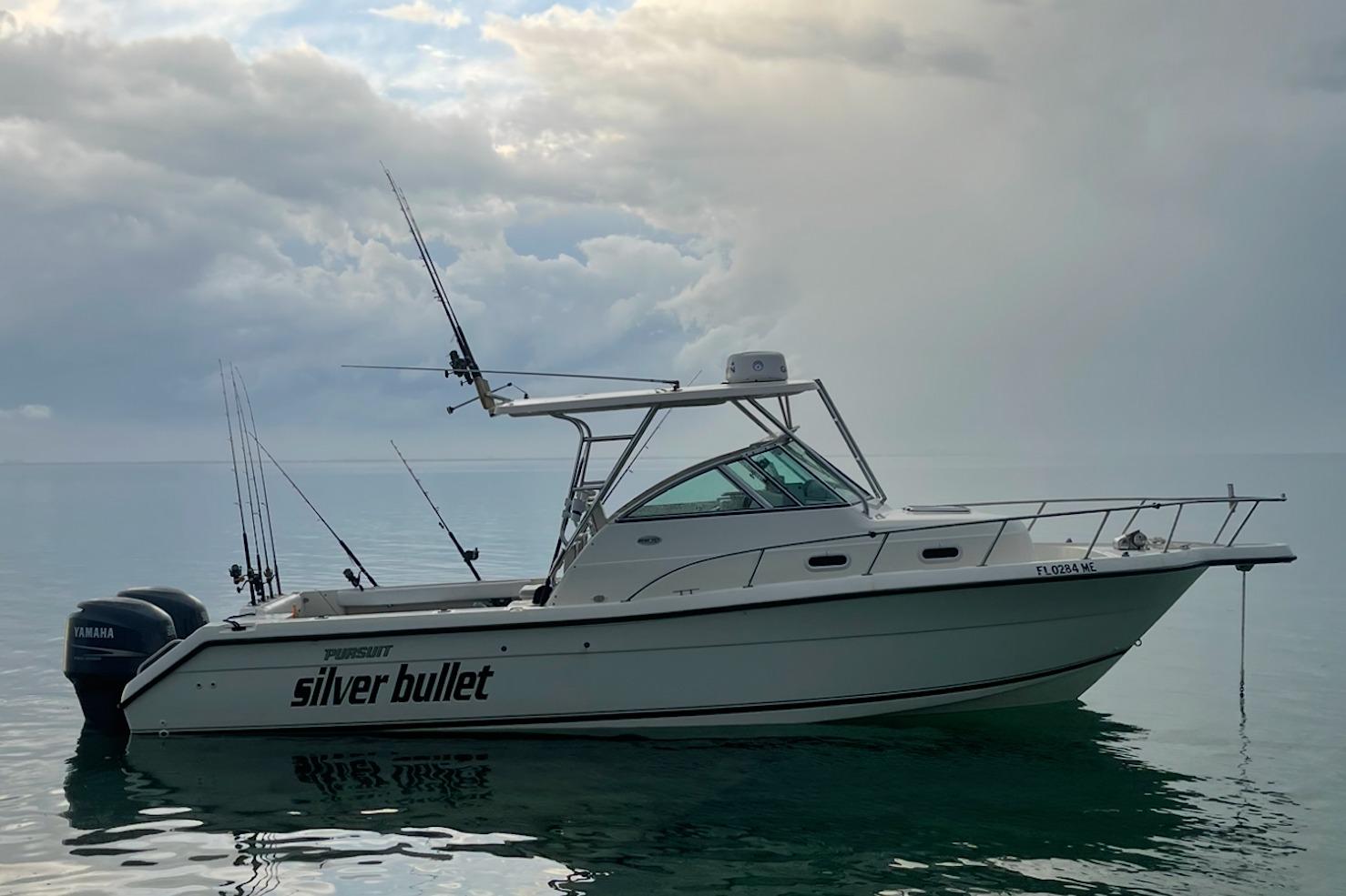 Pursuit 2870 Walkaround 2003 Pursuit 2870 Walkaround boat named "Silver Bullet" on calm water under cloudy sky.