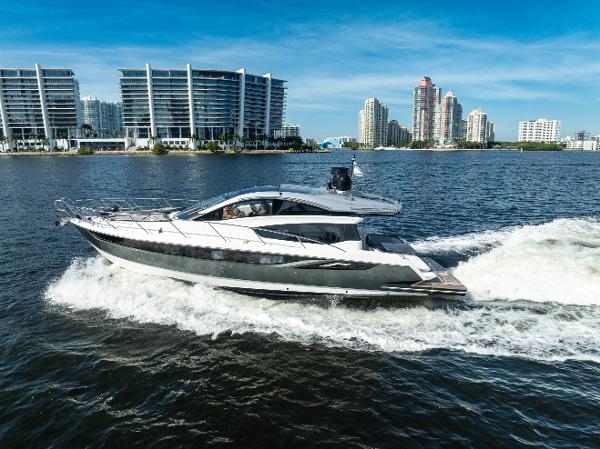 Galeon 430 HTC 2016 Galeon 430 HTC yacht cruising near modern waterfront buildings.