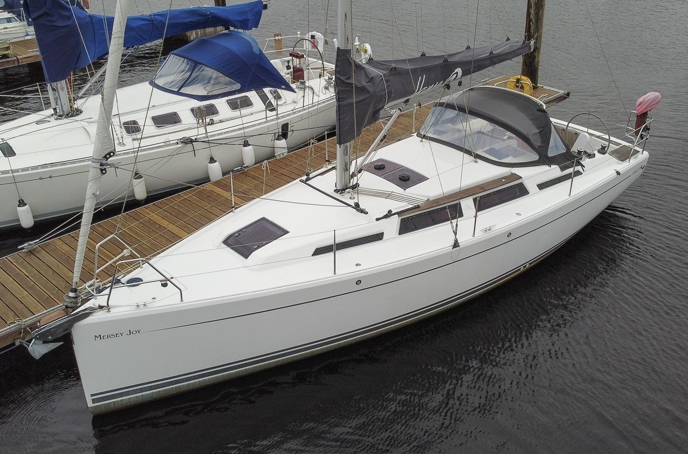 Hanse 345 2013 Hanse 345 sailboat docked at marina, featuring sleek white design and modern rigging.