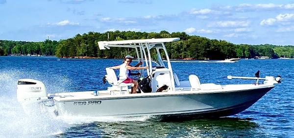 Sea Pro 248 Bay 2020 Sea Pro 248 Bay boat cruising on a lake with lush green trees in the background.