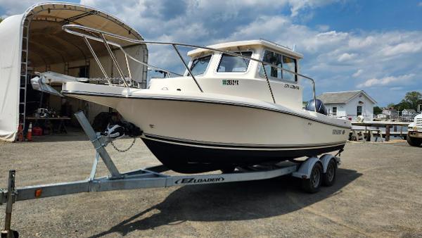 Defiance Admiral 220 EX 2021 Defiance Admiral 220 EX boat on trailer, parked outdoors under a partly cloudy sky.