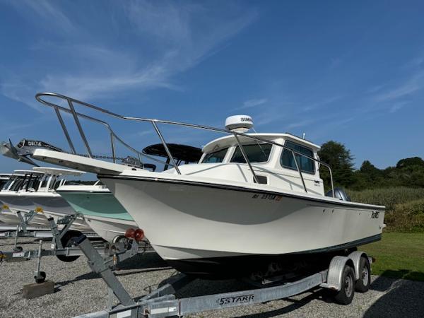 Parker 2320 Sport Cabin 2021 Parker 2320 Sport Cabin boat on trailer under clear blue sky.
