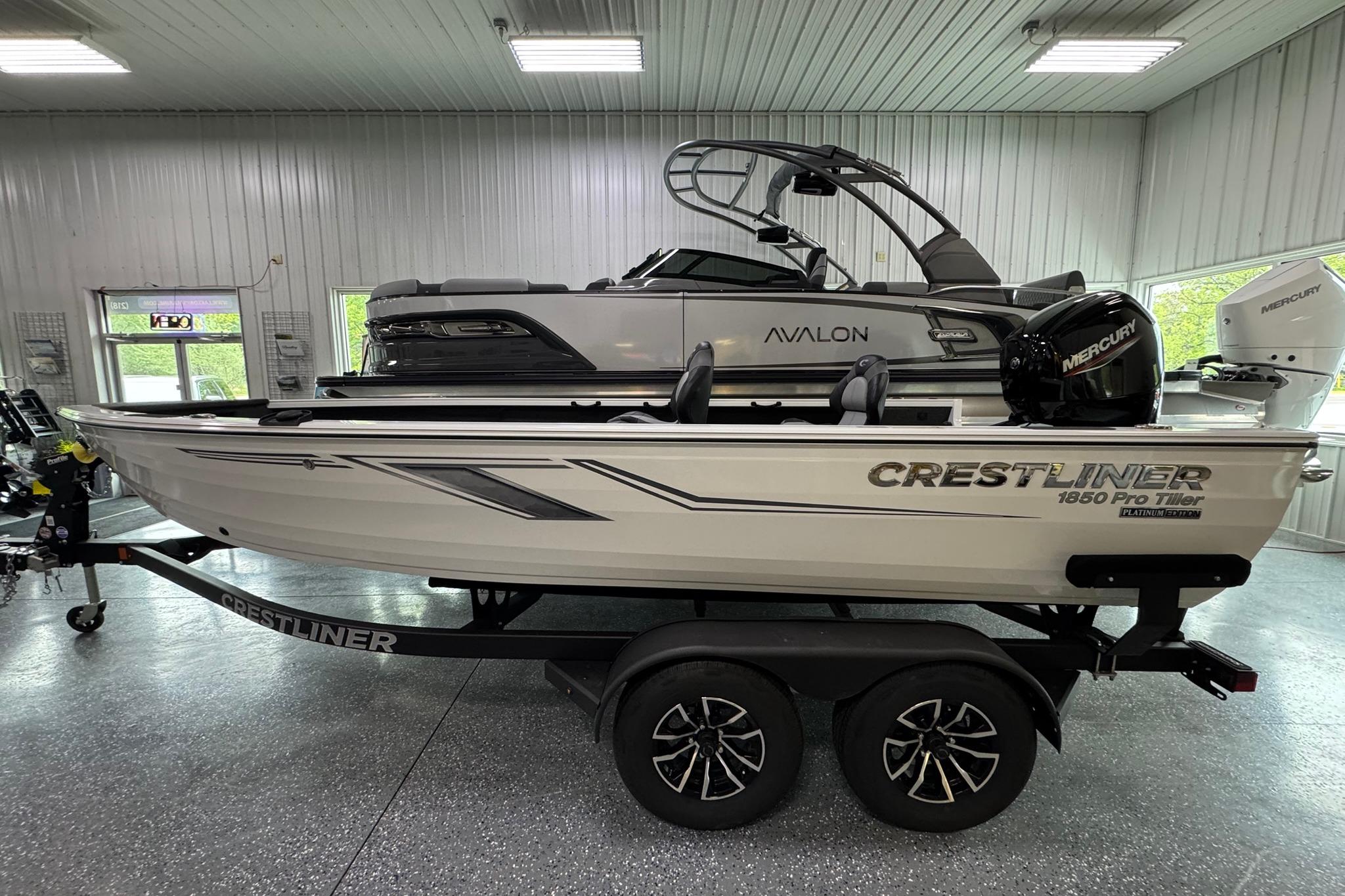 Crestliner 1850 Pro Tiller 2025 Crestliner 1850 Pro Tiller boat on trailer in showroom.