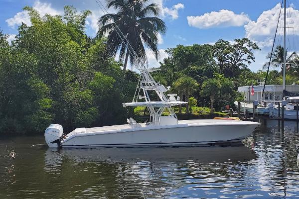 Bahama 41 FS 2014 Bahama 41 FS boat on a calm river, surrounded by lush greenery and palm trees.