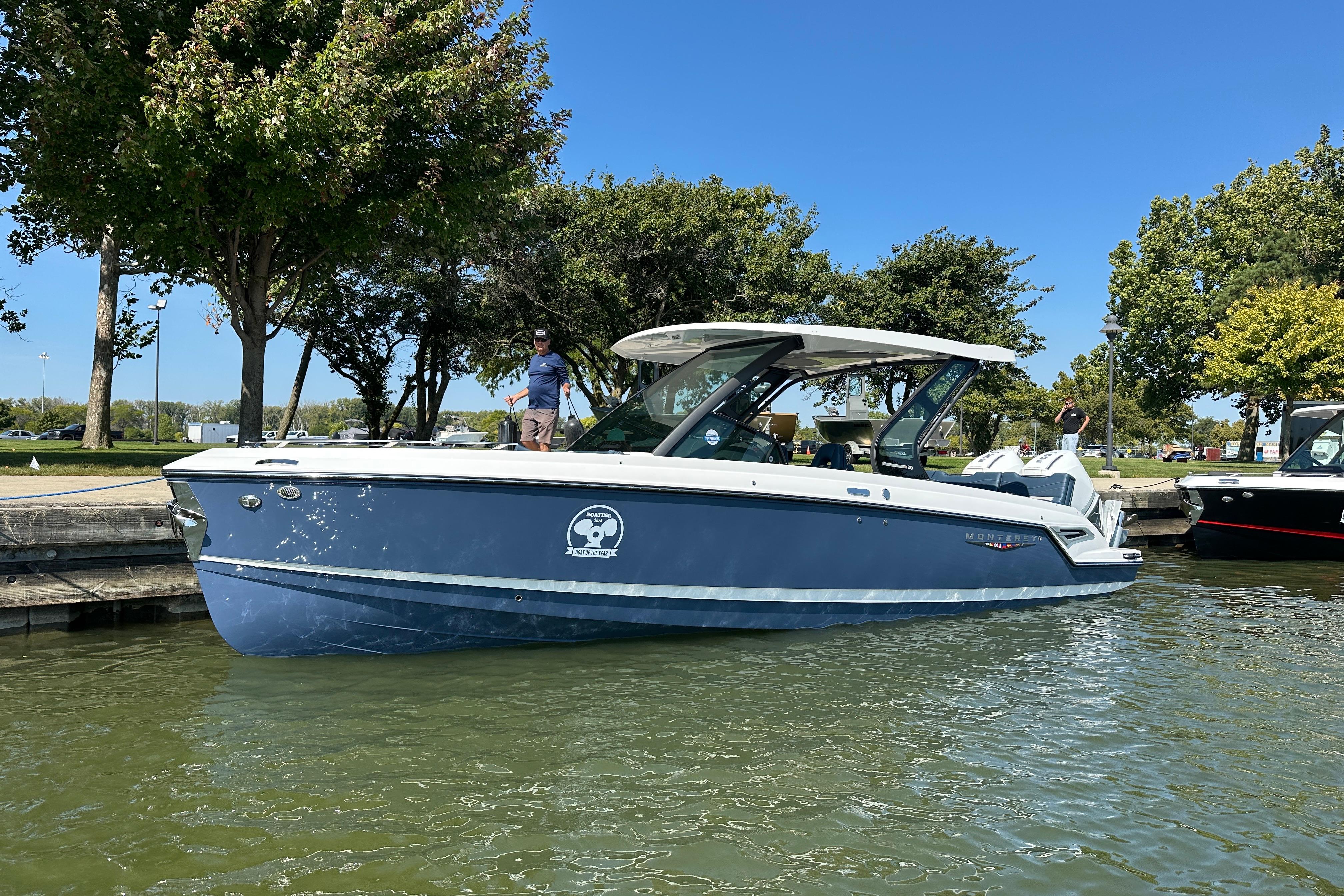 Monterey Elite 30 OB 2026 Monterey Elite 30 OB boat docked on a sunny day, surrounded by trees.