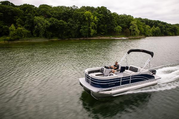 Harris 210 Cruiser 2023 Harris 210 Cruiser pontoon boat cruising on a scenic lake with lush green trees.