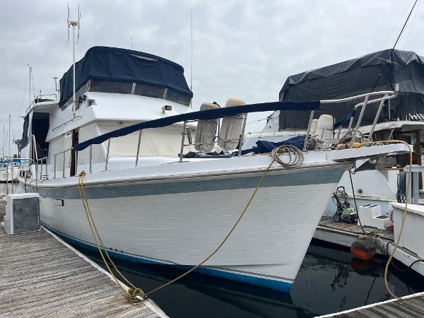 CHB 46 Motor Yacht 1988 CHB 46 Motor Yacht docked at marina, covered upper deck, white hull.