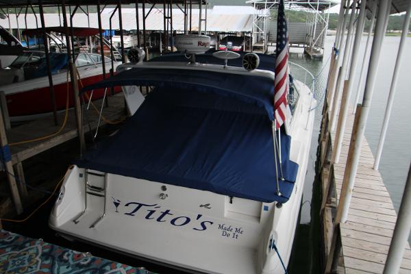 Sea Ray 330 Sundancer 1994 Sea Ray 330 Sundancer docked with blue cover and American flag.