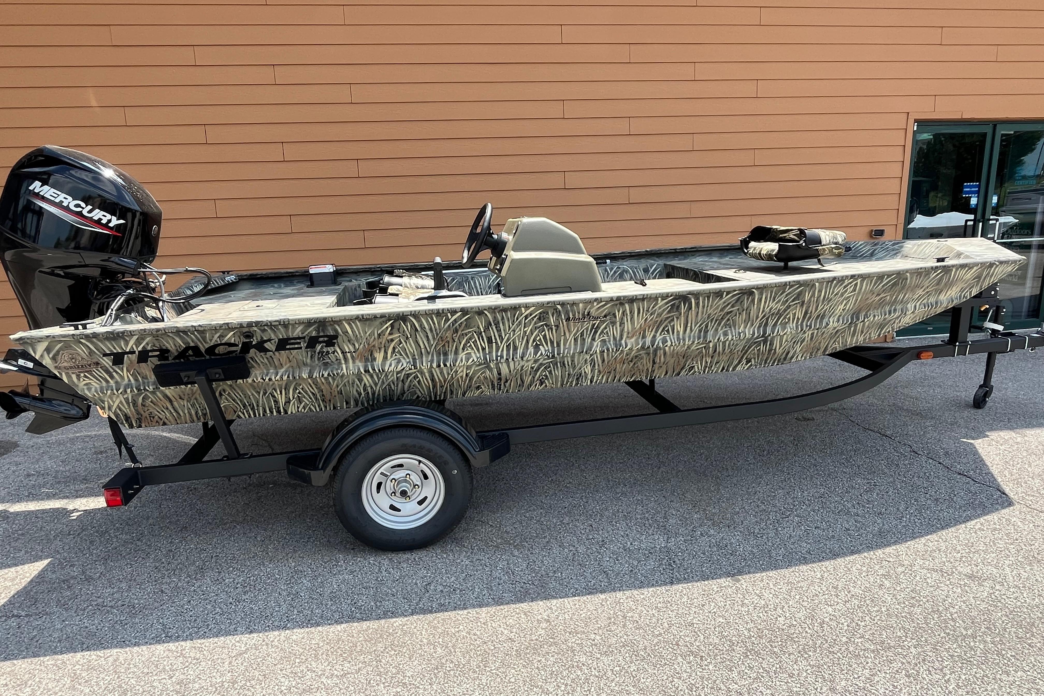 Tracker Grizzly 1754 SC 2026 Tracker Grizzly 1754 SC boat with camouflage design and Mercury outboard motor.