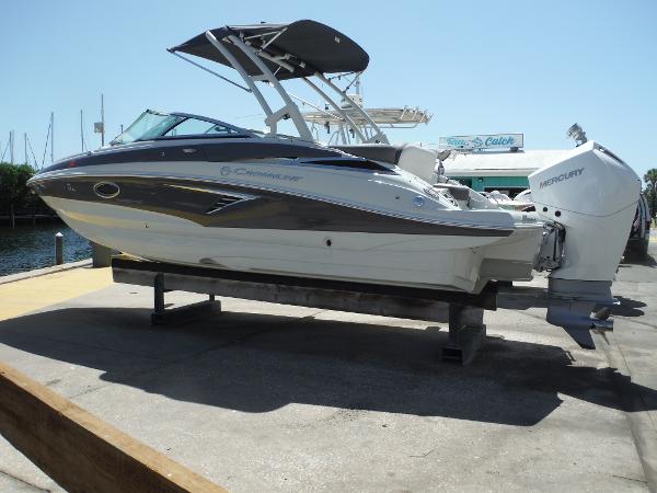 Crownline Eclipse E235 XS 2023 Crownline Eclipse E235 XS boat with Mercury engine on display at a marina.