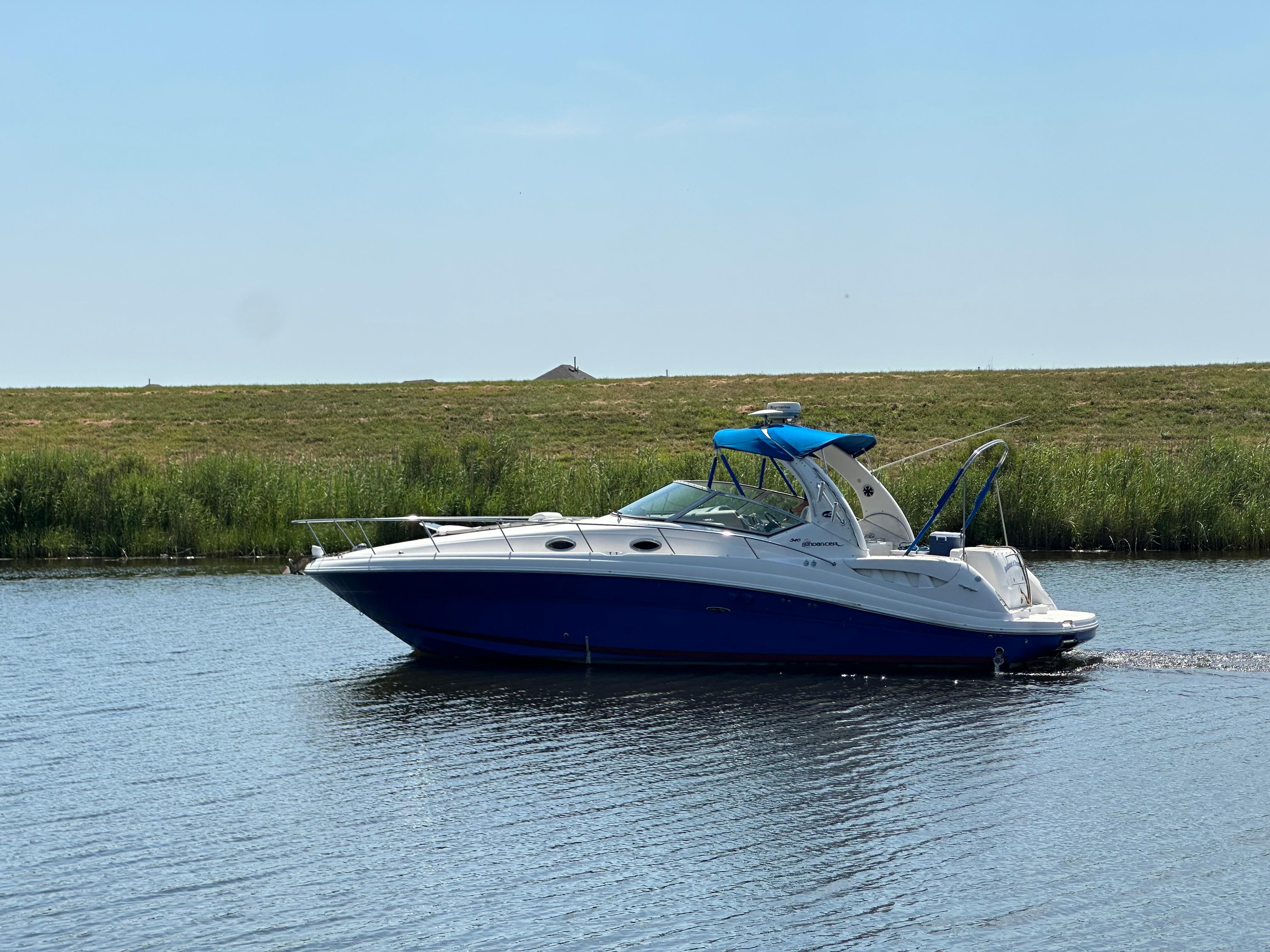 Sea Ray 340 Sundancer 2006 Sea Ray 340 Sundancer cruising on a calm lake under a clear blue sky.