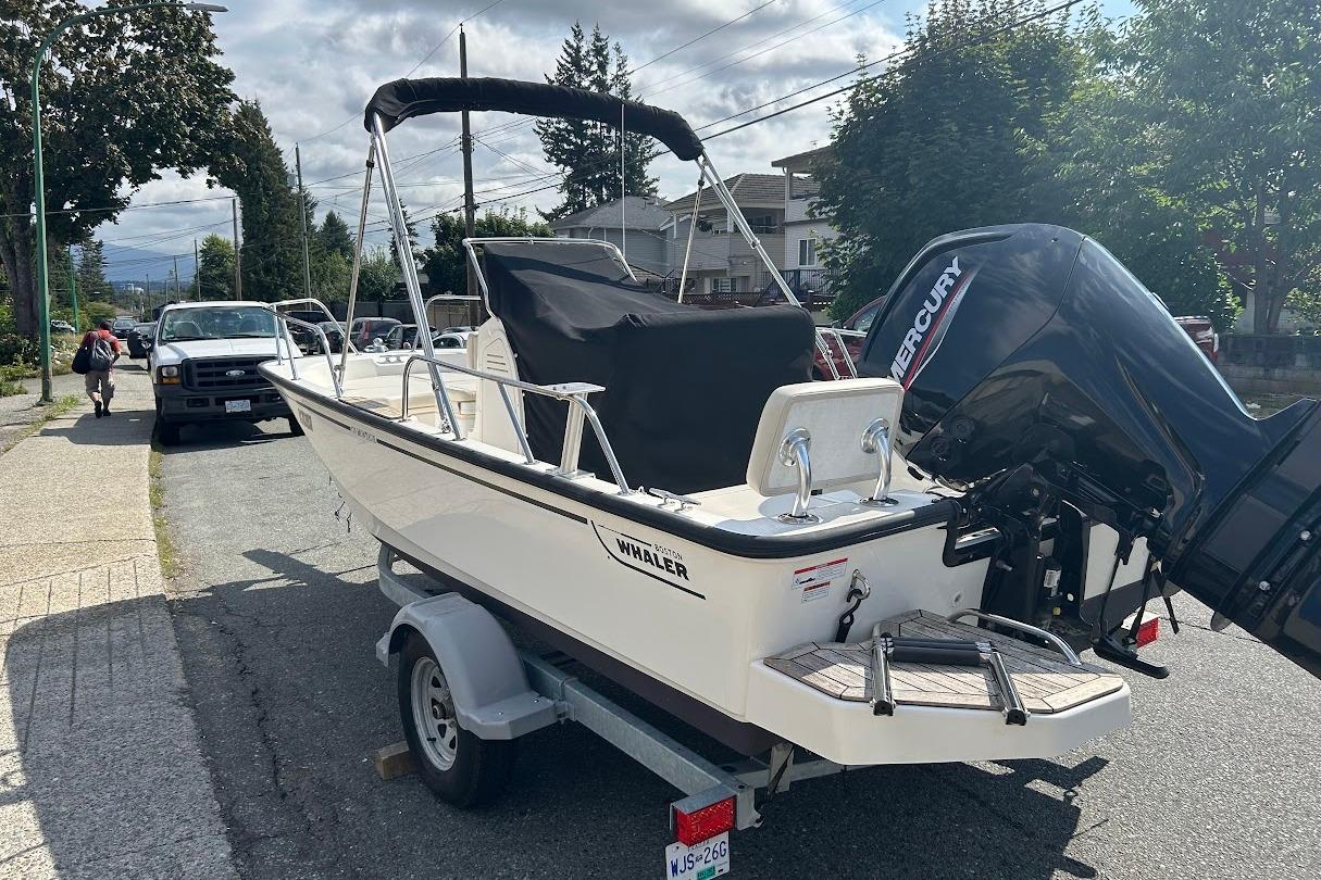 Boston Whaler 17 Montauk 2021 Boston Whaler 17 Montauk boat on trailer, parked on a residential street.