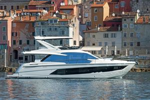 Absolute 62 Fly 2019 Absolute 62 Fly yacht docked near colorful waterfront buildings.