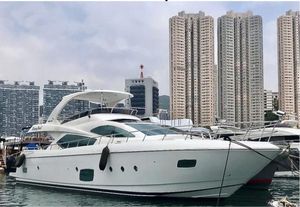 Ruby 65s Luxurious 2012 Ruby 65s yacht docked in urban marina with skyscrapers in background.