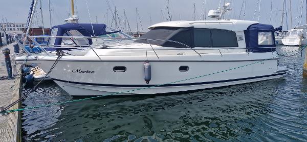 Nimbus 365 Coupe 2x 225HP Nimbus 365 Coupe 2014 boat docked in marina, side view.