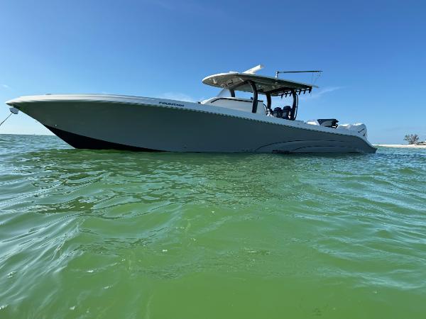 Fountain 43NX 2019 Fountain 43NX boat on calm green water under clear blue sky.