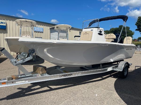 Sea Pro 202 CC 2024 Sea Pro 202 CC boat on a Load Rite trailer, parked outdoors.