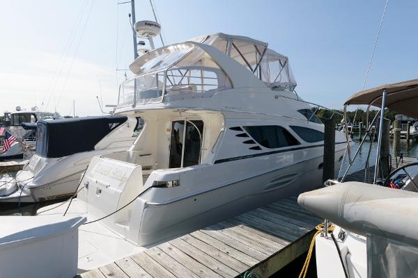Silverton 43 Sport Bridge 2006 Silverton 43 Sport Bridge yacht docked at a marina under clear skies.