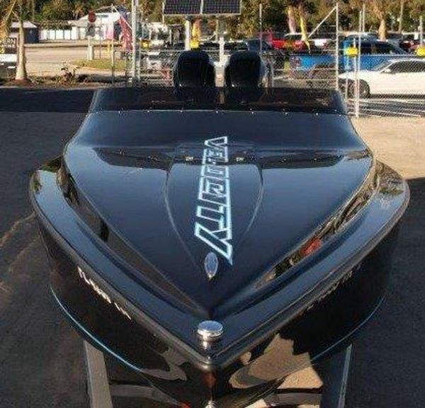 Velocity 290 Sc 2022 Velocity 290 Sport Cruiser, sleek black design, parked outdoors.