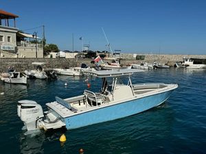 Jupiter 31 Center Console 2004 Jupiter 31 Center Console boat docked in a scenic harbor with clear blue water.