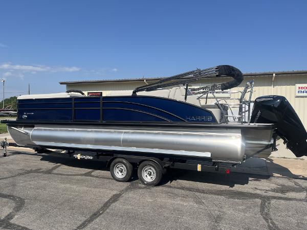 Harris Cruiser 250 2025 Harris Cruiser 250 pontoon boat on trailer, parked outdoors.