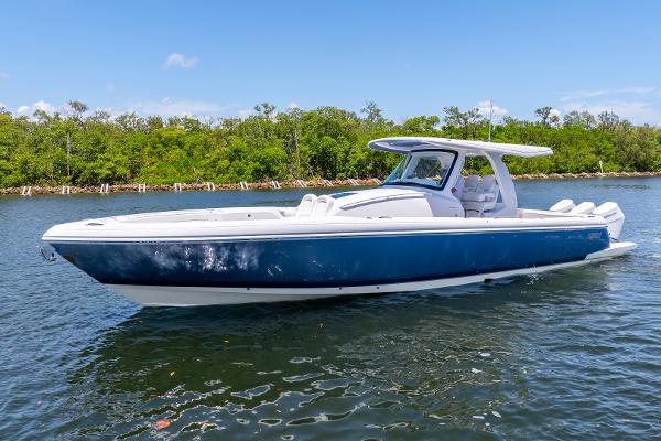 Intrepid 41 Panacea 2025 Intrepid 41 Panacea boat on calm water, surrounded by lush greenery.