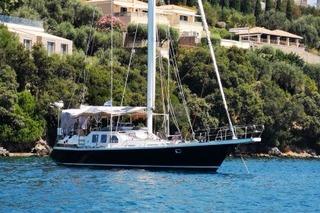Meta 60 Sailboat anchored near lush coastline, Meta 60 model, 1991.
