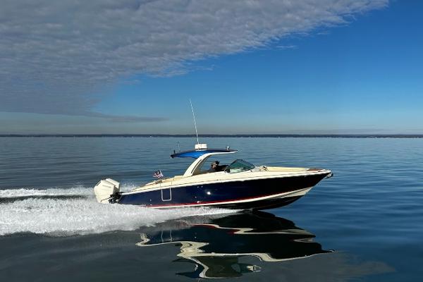 Chris-Craft LAUNCH GT 35 2024 Chris-Craft LAUNCH GT 35 cruising on calm water under a clear sky.