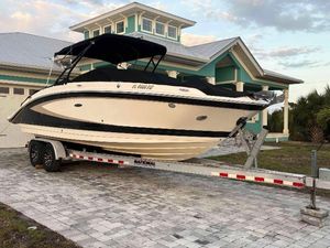 Sea Ray SDX 270 Outboard 2015 Sea Ray 270 SDX boat on trailer, parked in front of a modern house.