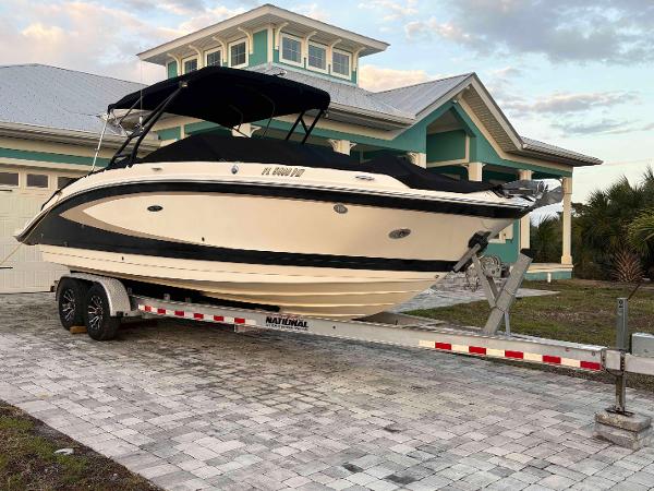 Sea Ray SDX 270 Outboard 2015 Sea Ray 270 SDX boat on trailer, parked in front of a modern house.